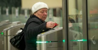 Passenger passes turnstiles at Moscow metro station.