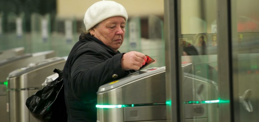 Passenger passes turnstiles at Moscow metro station.